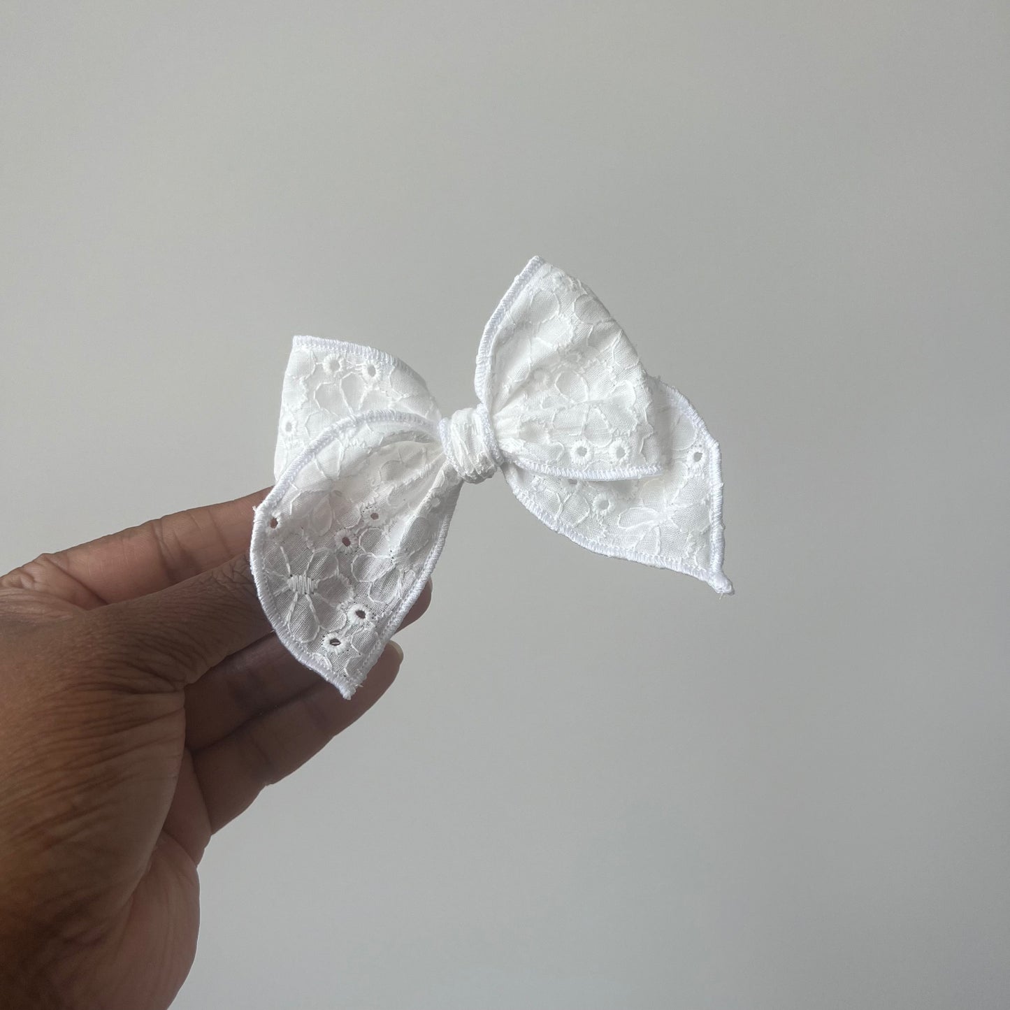 white eyelet long tailed bow